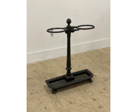 A Victorian cast iron stick stand, two divisions on an ionic column and above a drip tray, raised on splayed supports. H70cm.