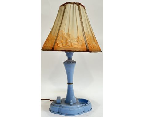 An early plastic/Bakelite Art Deco lamp with quatrefoil blue base, tapered stem and early plastic shade with reflief moulded 