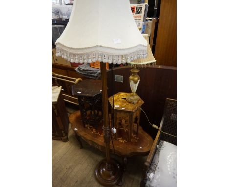 A carved hardwood standard lamp complete with shade, painted cream and gold table lamp complete with shade (2).