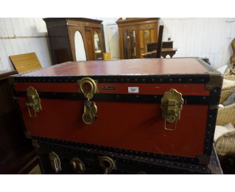 A red and black Mossman of London school trunk.