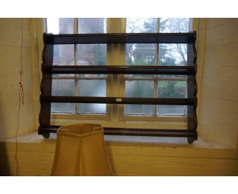 An 18th Century style oak wall mounted four shelf plate rack, each shelf with grooving.