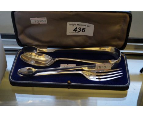A cased Sheffield hallmarked silver christening set comprising spoon and fork, together with a further silver pair of sugar t