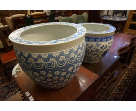 A large Chinese blue and white ceramic planter with extensive floral decoration, and a similar blue and white ceramic planter
