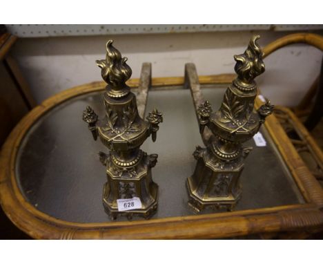 A pair of cast brass French Louis XVIII style andirons decorated with flowers and flaming torch finial.