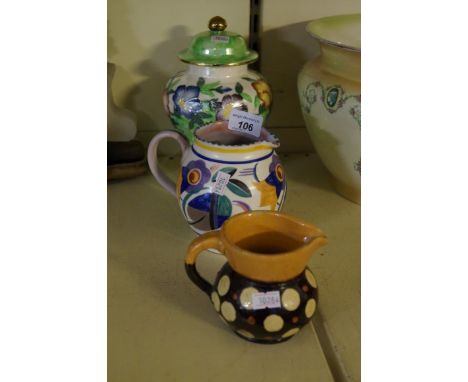 A Maling lustre temple jar and cover having floral decoration, together with Poole Pottery Art Deco jug, a slipware jug.