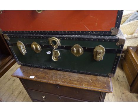 A green and black Mossman of London school trunk.