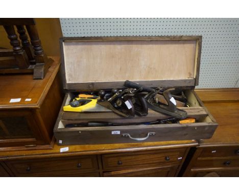 A wooden carpenters tool chest containing two Stanley wood planes, a further larger Stanley wood plane, Estwing hammer furthe