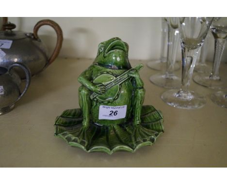 An unusual Rye Pottery inkwell modelled in the form of a frog playing the banjo seated on a lily pad. CONDITION REPORT: 14cm 