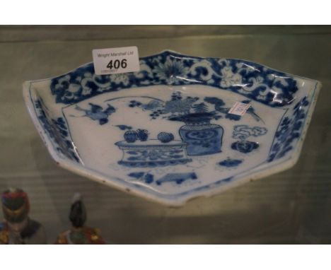 An 18th Century European ceramic shield shape dish, in the Chinese taste, with floral borders and central panel depicting a g