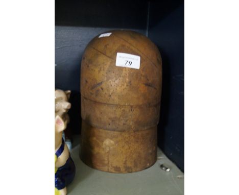 A vintage wooden hat block.