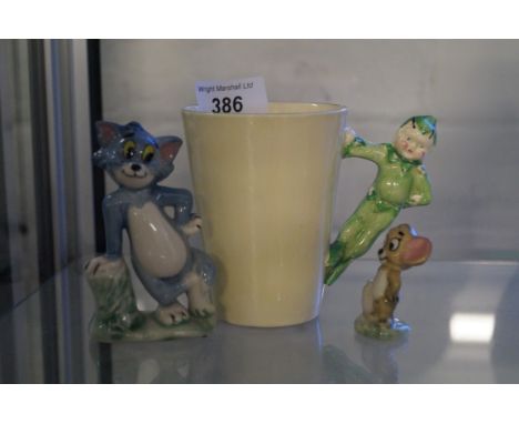 A Wade Tom and Jerry ceramic figure set together with a Clarice Cliff modelled with an imp handle (3)