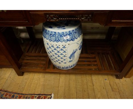 A Chinese ceramic blue and white garden seat decorated with flowers.