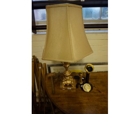 A reproduction candlestick brass and black painted telephone, together with a gilt metal table lamp.