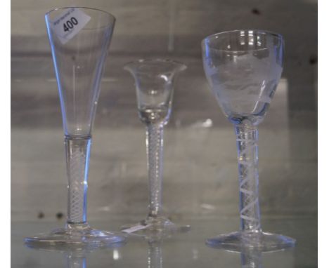 Three 18th Century style wine glasses, each with air twist stems to include an example having engraved decoration to bowl dep