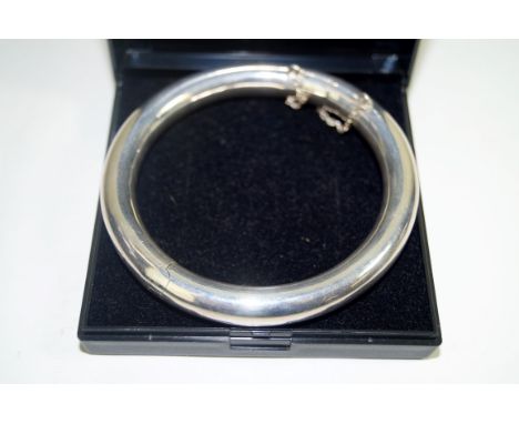 A silver hinged bangle, A.f., of plain circular form 