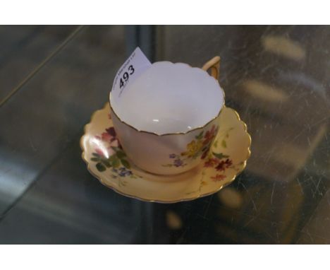 A Royal Worcester blush ivory cup and saucer.