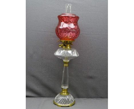 VICTORIAN STYLE OIL LAMP, mixed brass and glass column base with cut glass font and molded cranberry glass shade, 72cms overa