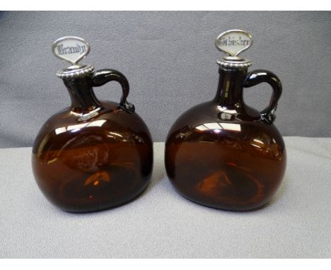 19TH CENTURY AMBER GLASS SPIRIT FLAGONS, a pair, having white metal collar mounts and mother of pearl topped corks, named 'Br