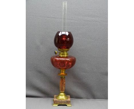 CIRCA 1900 OIL LAMP with brass and pink marble base, etched pattern cranberry font and modern ruby red shade, 62.5cms H