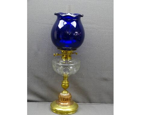 VICTORIAN OIL LAMP with brass and copper column base, cut glass font and reproduction Bristol blue shade, 65.5cms H