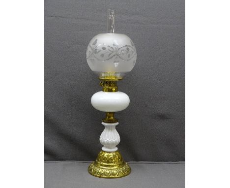 BRASS &amp; WHITE MILK GLASS VICTORIAN OIL LAMP with decoration in relief and frosted globular shade, 55cms overall height