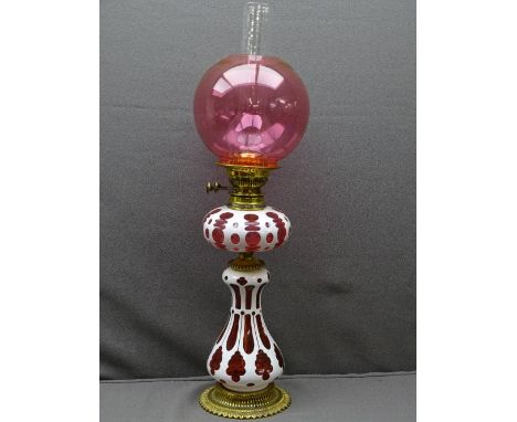 CAMEO CUT GLASS VICTORIAN OIL LAMP, brass with Bohemian type Ruby overlay, bulbous base and font with reproduction cranberry 