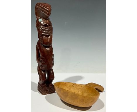 A New Zealand Maori carving, with mother of pearl eyes; a ladle 