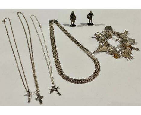 A silver charm bracelet, assorted silver charms, Concorde, swan with internal ballerina, acorn with internal squirrel, skull,