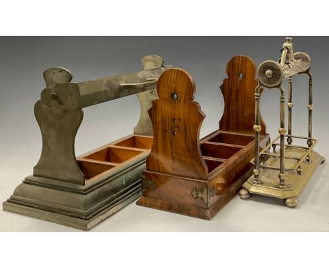 An Edwardian brass three bottle tantalus frame, the mobile scroll handle locking with a key, above knopped supports on a cant