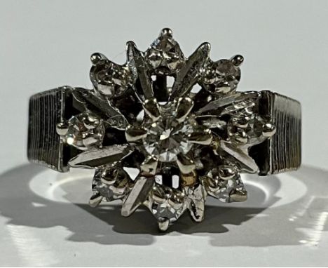 A  white gold and diamond cluster ring, ribbed shoulders, open petal mount 
