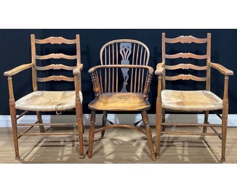 A 19th century yew, beech, ash and elm Windsor elbow chair, 90cm high, 53.5cm wide; a pair of vernacular ladder back armchair