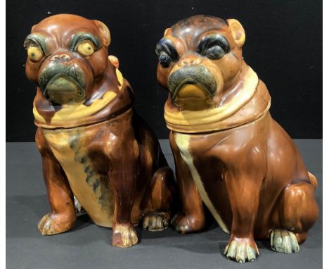 A 19th century majolica tobacco jar, in the form of a pug dog, seated wearing a yellow collar with lilac bow, 21cm high, c.18