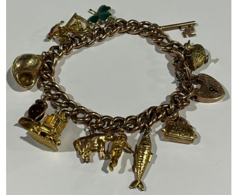 A 9ct gold charm bracelet, padlock clasp, suspending various 9ct gold and yellow metal charms, including fish, shell, cow, la