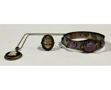A sterling silver hinged bangle, set with three polished amethyst cabochons, safety chain; a Wedgwood Jasperware pendant, sil