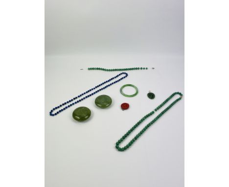 A collection of Chinese jade and hardstone jewellery to include a bangle, 8cms diameter, two green beaded necklaces, a shaped