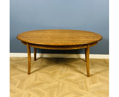 An Ercol oval shaped coffee table, Ercol label to the underside, 122.5cms wide x 77cms deep x 51cms high. Estimate £60-80.