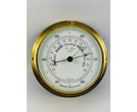 A brass cased circular bulkhead aneroid circular barometer with a bevelled glass, signed St James, London. 20.5cms diameter x