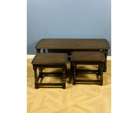 A set of Ercol nesting tables to include a long coffee table, 114.5cms long x 50cms deep x 41cms high and two smaller tables,