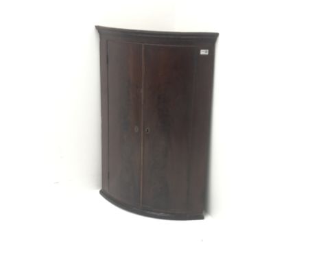 Georgian mahogany bow front corner cupboard, two doors enclosing three shelves, W71cm, H103cm, D46cm Condition Report Click h