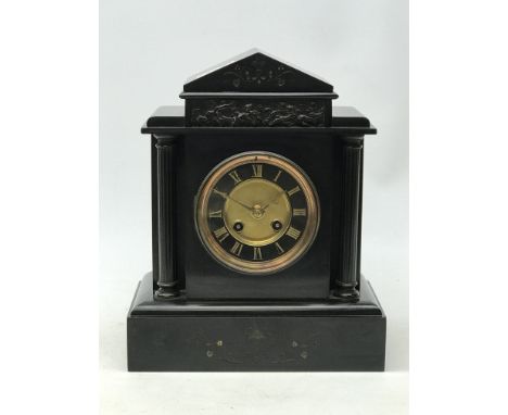 Victorian black slate mantle clock, black and gilt circular Roman dial, flanked by reeded columns below classical bronze frie