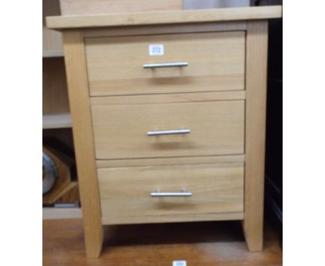 A light oak finished three draw bedside chest 