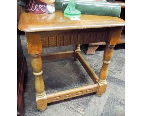 A reproduction light oak coffee table 