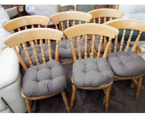 A set of six pale pine finished stick back Windsor dining chairs with brown seat pads 