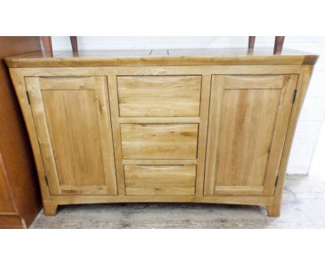 A rustic style light oak sideboard fitted cupboards and centre drawers, 4'6 wide 