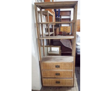 A light oak finished bamboo style and wicker open bookcase with three drawers under 