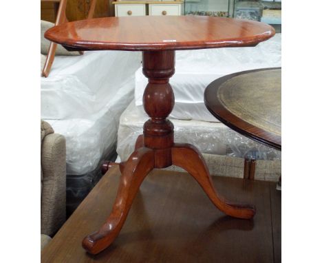 A circular mahogany occasional table on pillar and tripod base 