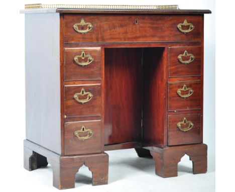 An impressive early 19th Century Georgian English antique Gillows manner mahogany knee hole desk having a brass gallery rail 