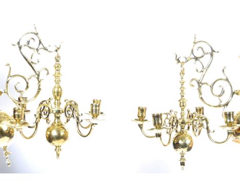 An antique 19th century pair of brass hanging chandeliers, in the 17th Century Dutch manner. Each wall sconce hanging bracket