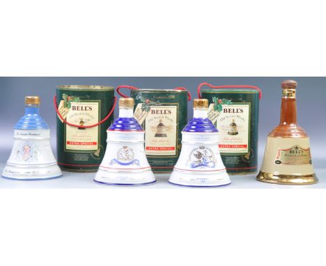 A good group of seven porcelain Bell's Old Scotch Whisky decanters and contents to include Christmas 1988, 1989 and 1990 case