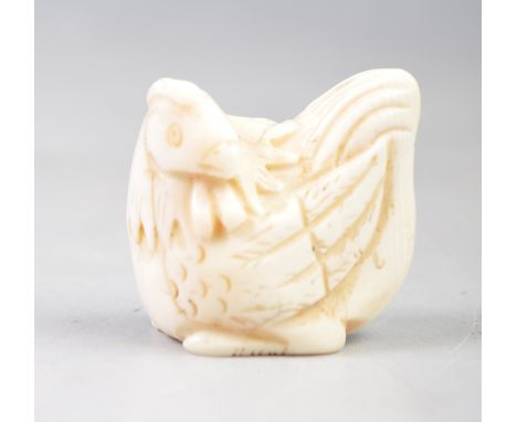 A 19th Century Japanese antique Meiji period hand carved ivory netsuke in the form of a Chicken Hen. Fixing holes to body and